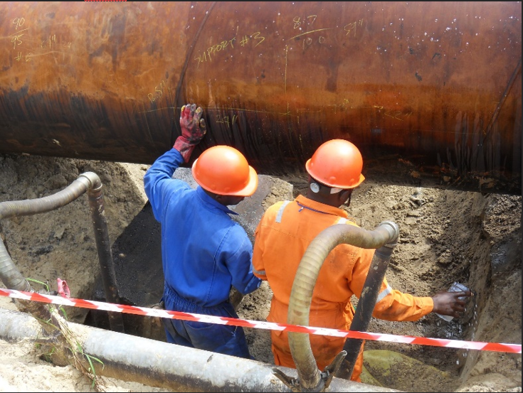 Men wearing hard hats and orange helmets
                                
                                Description automatically generated